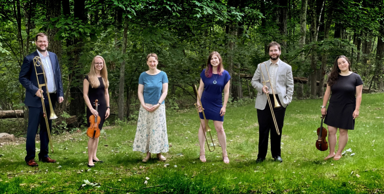 Incantare members pose with early instruments